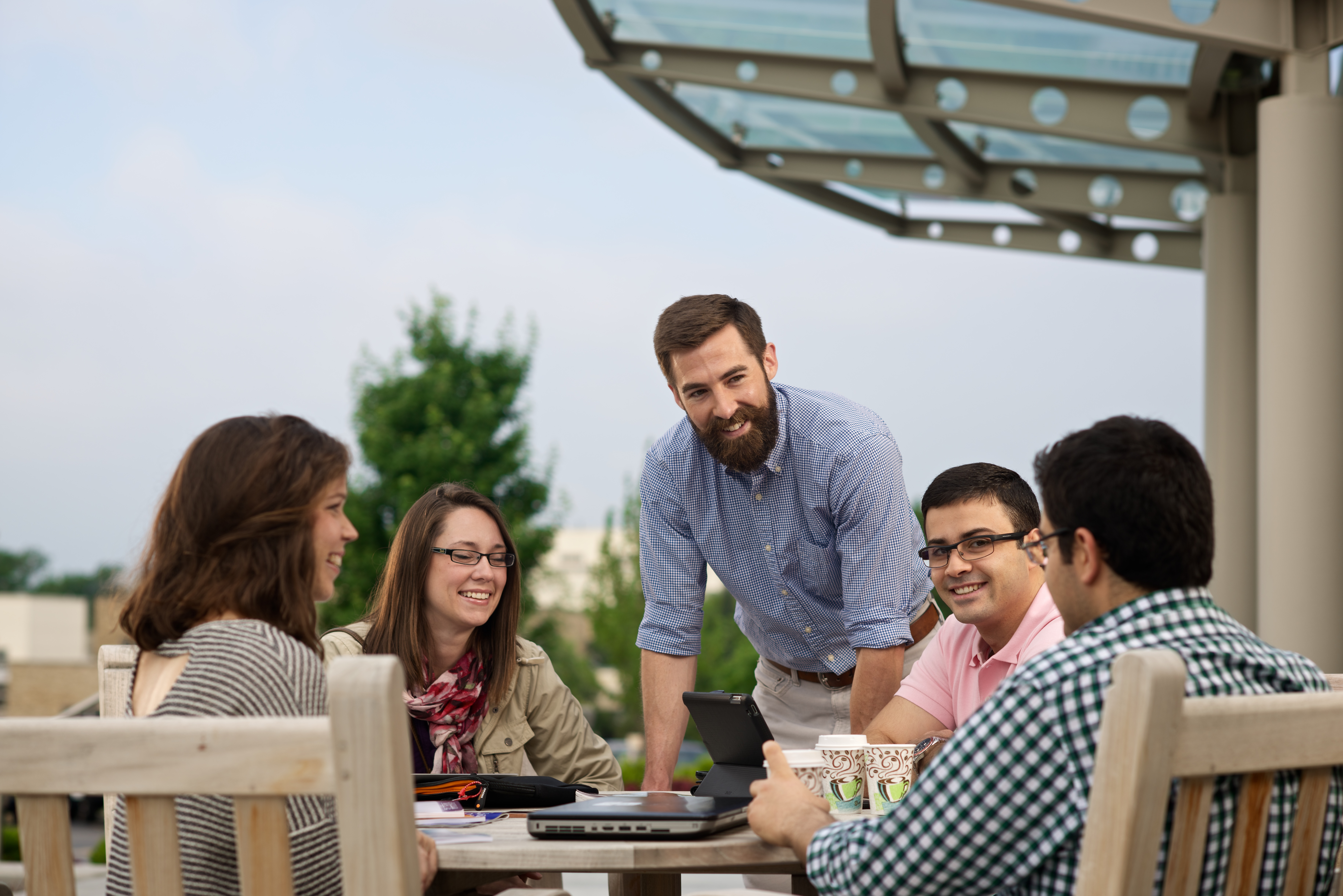 Employees collaborating around a table on the OU-Tulsa campus.
